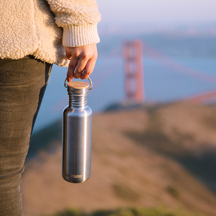 27oz-reflect-with-bamboo-cap-l0 K27SSLRF-BS-BAMBOO_reflect_bottle_bridge_lifestyle.jpg